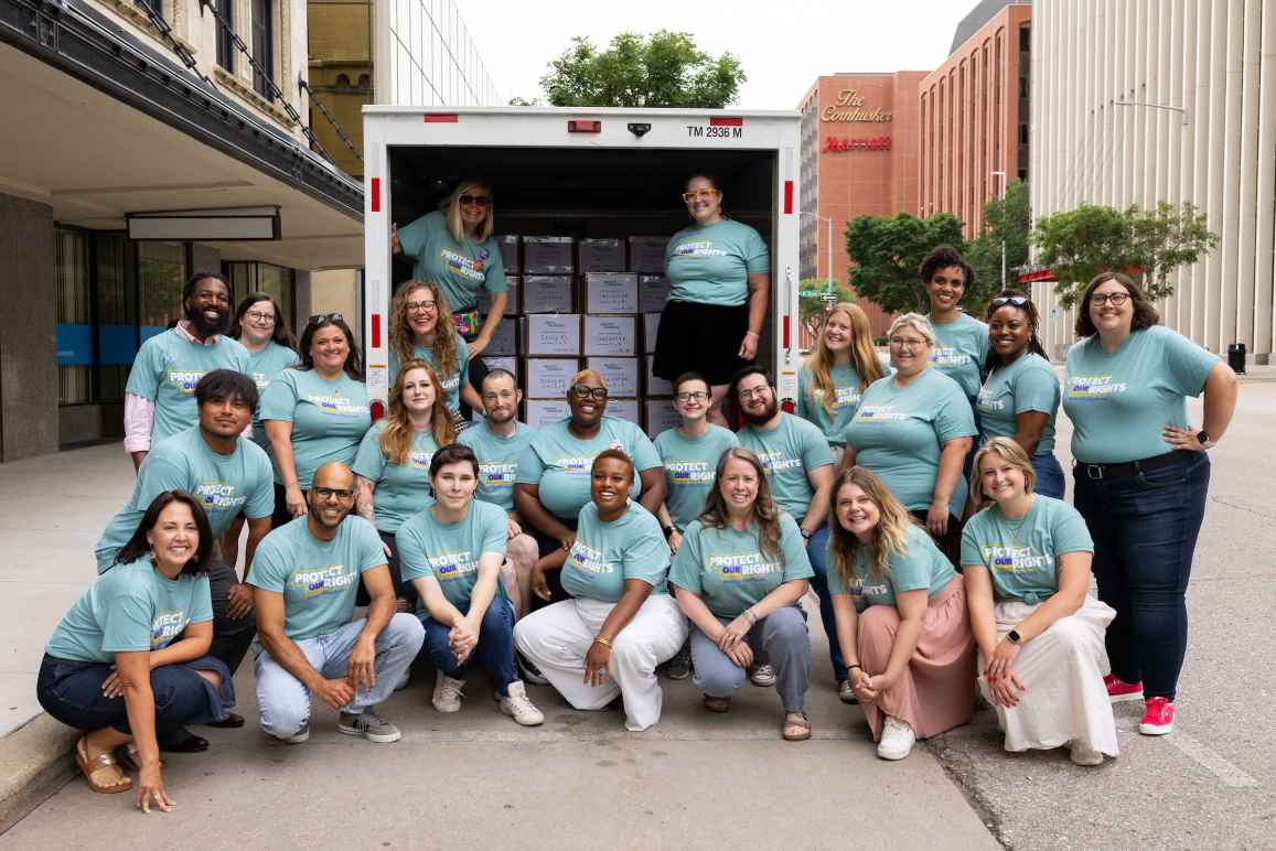 Coalition members, including several ACLU of Nebraska staff members, pose in front of a U-Haul truck holding more than 207,000 signatures supporting abortion rights in Nebraska.