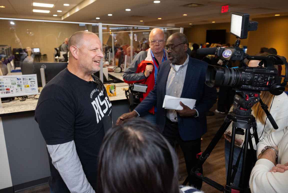 Omahan Jason Kotas talks with reporters after registering to vote a few hours after the Nebraska Supreme Court issued its ruling.