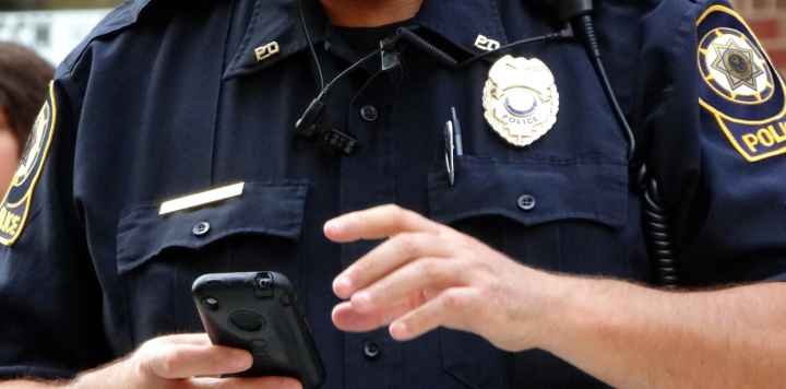 Law enforcement officer with a cell phone
