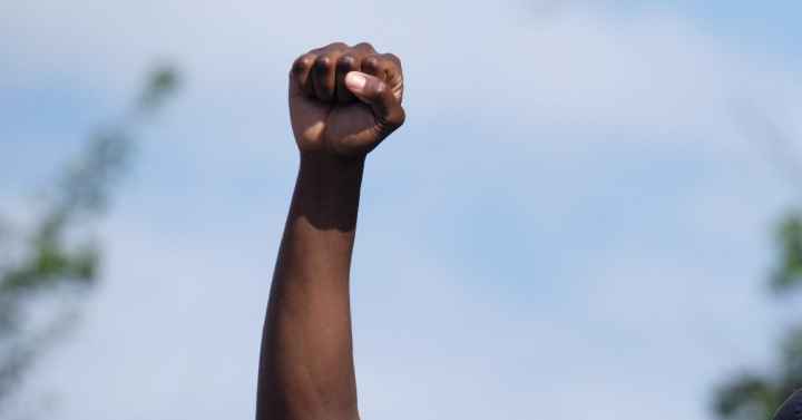 A man holds a fist in the air during a Nebraska protest following the killing of George Floyd.