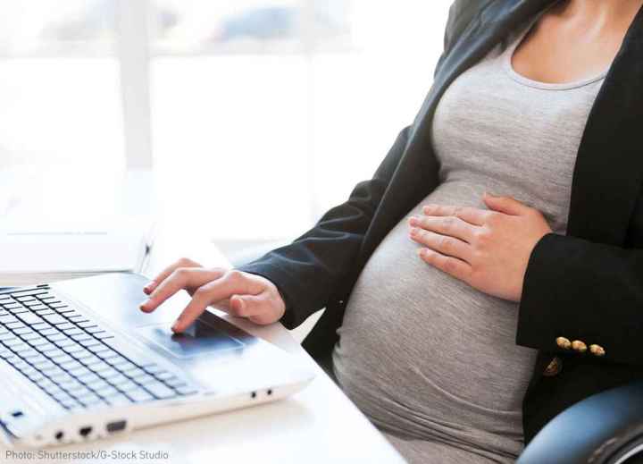 Pregnant woman at desk