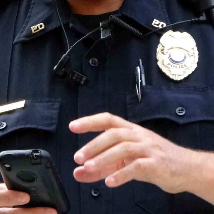 Law enforcement officer with a cell phone