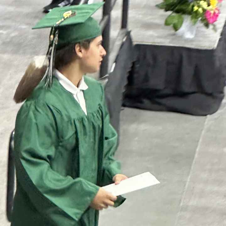 Christina Running Hawk-Ellison’s son Brody walks off the stage during his high school graduation ceremony in Omaha.