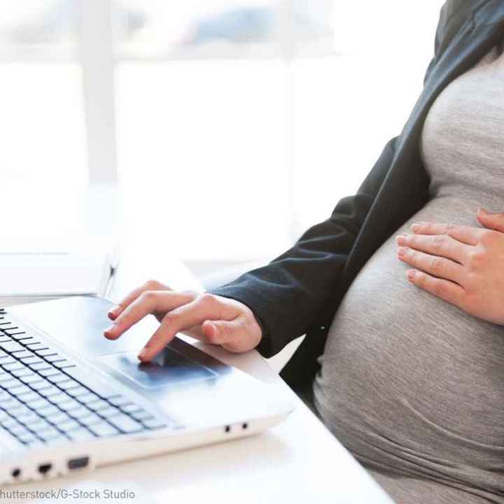 Pregnant woman at desk
