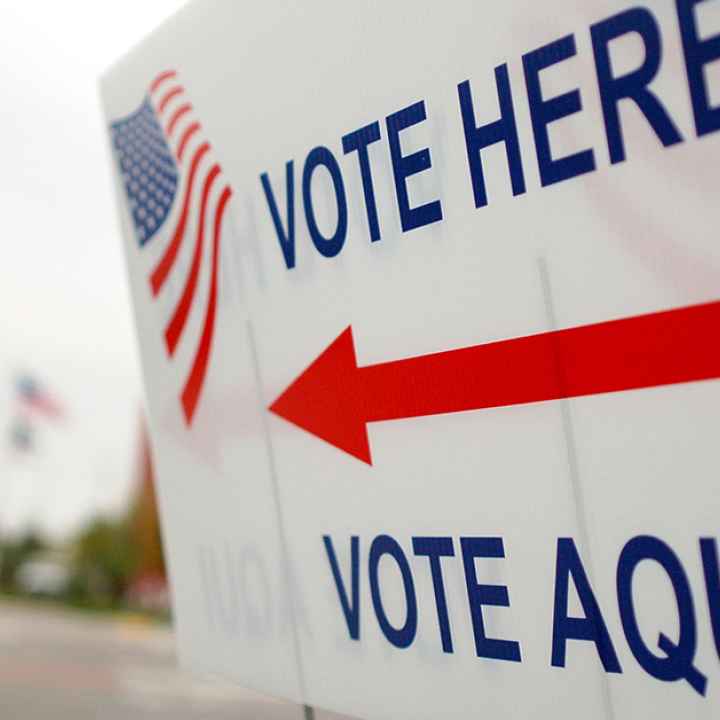 Sign near a polling place saying "Vote Here" and "Vote Aqui"