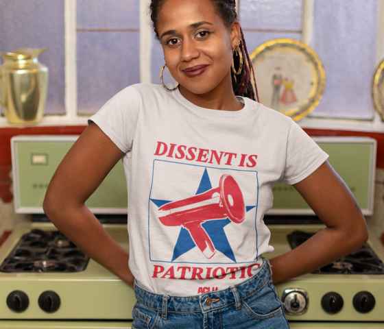 A woman wears a shirt reading dissent is patriotic